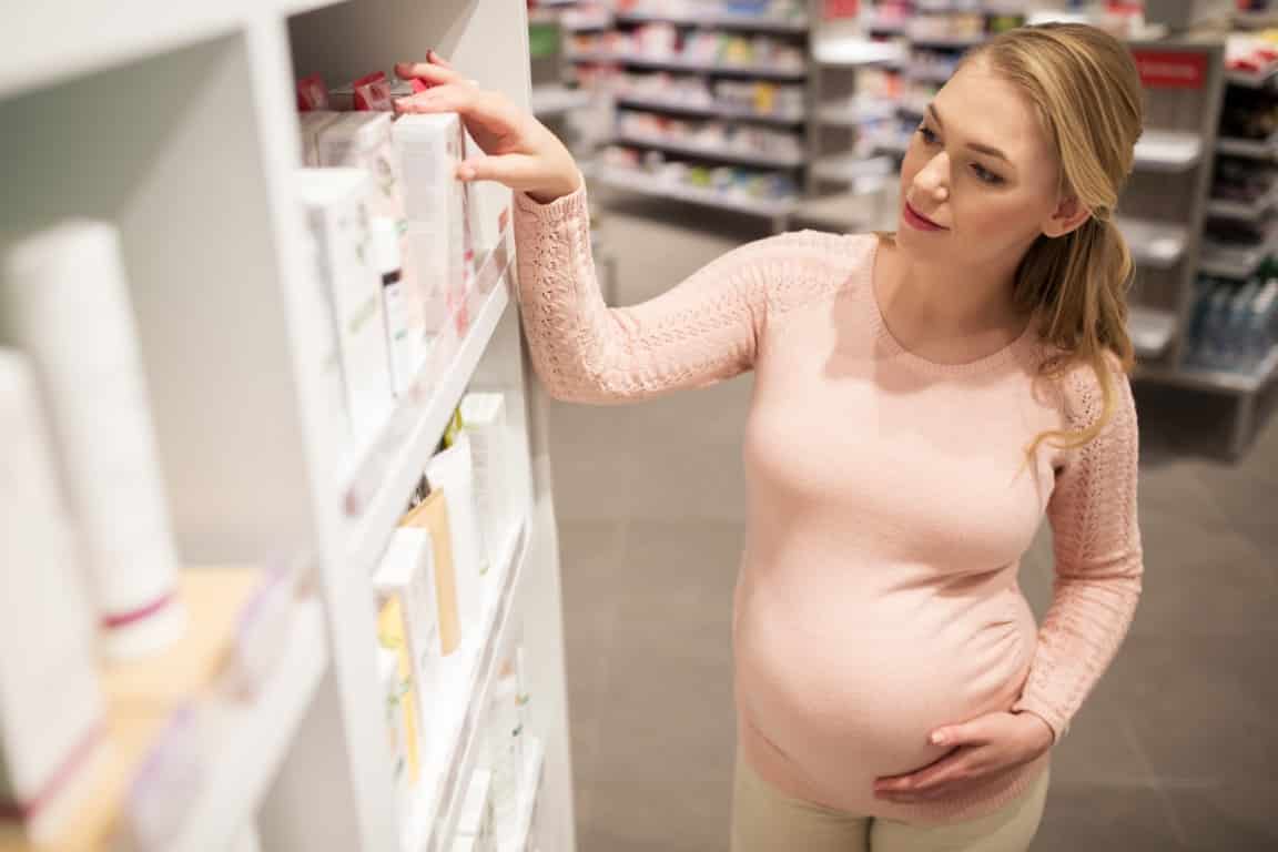femme enceinte qui choisit ces cosmétiques en magasin